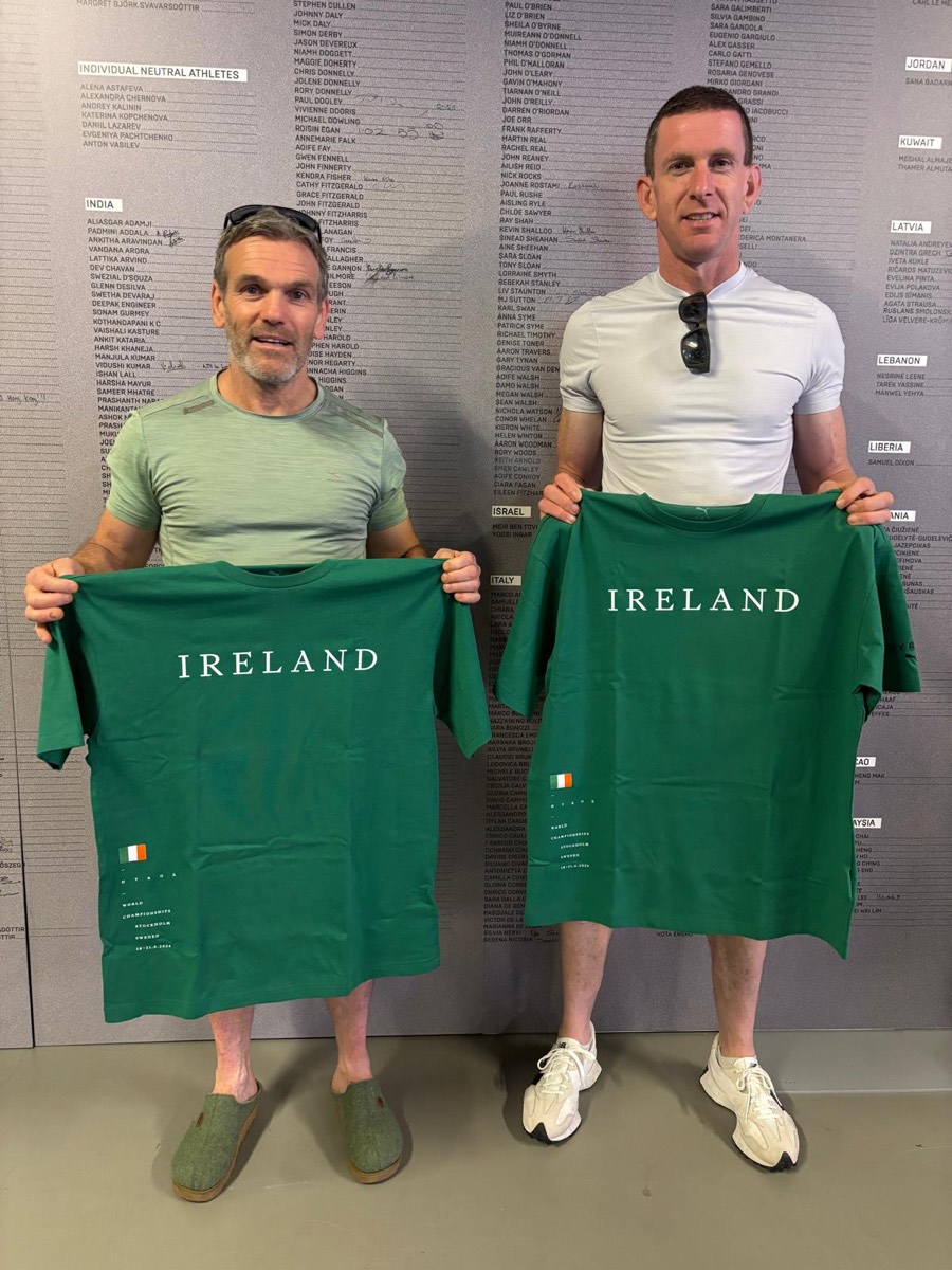 Conor and his doubles partner holding Ireland shirts at the Hyrox World Championships in Stockholm