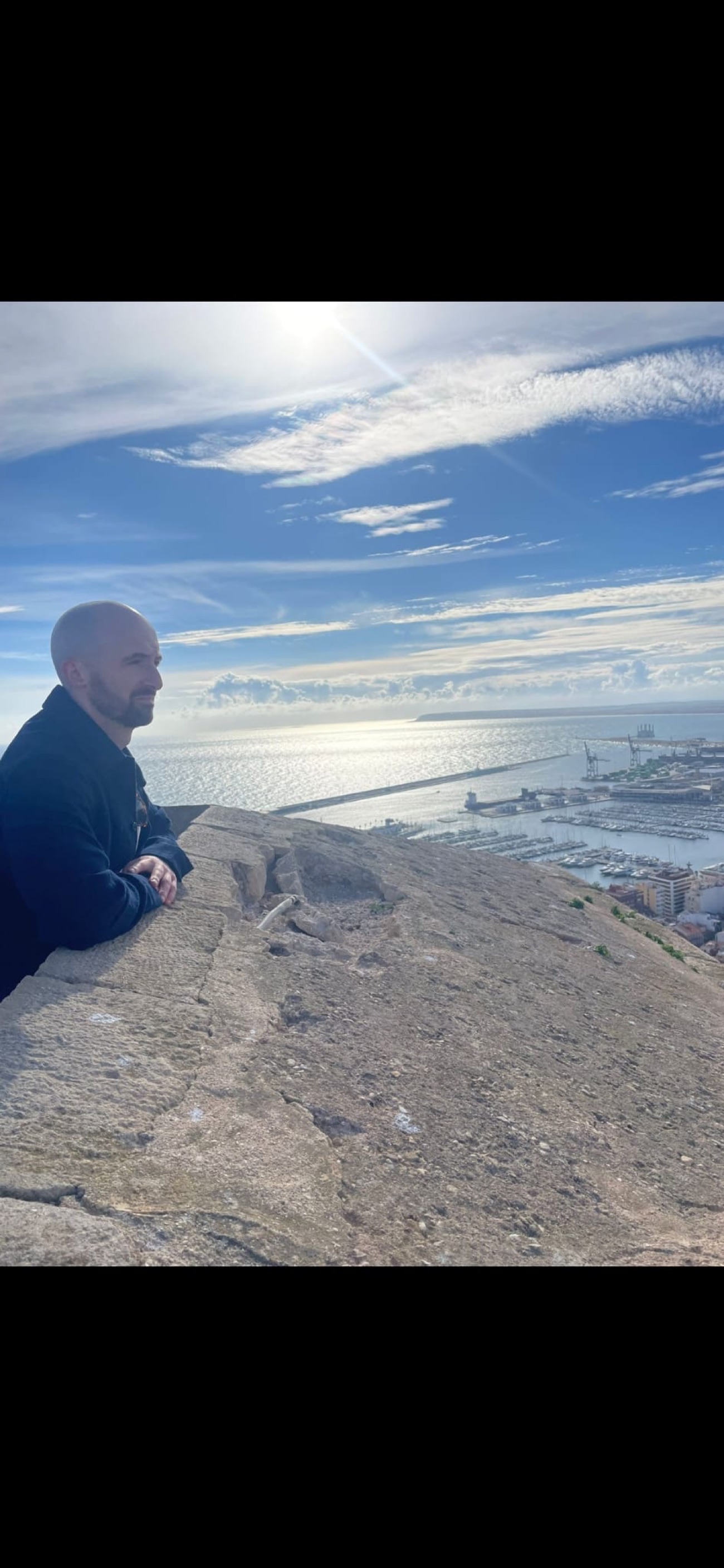 Owen Costello looking out over a harbour