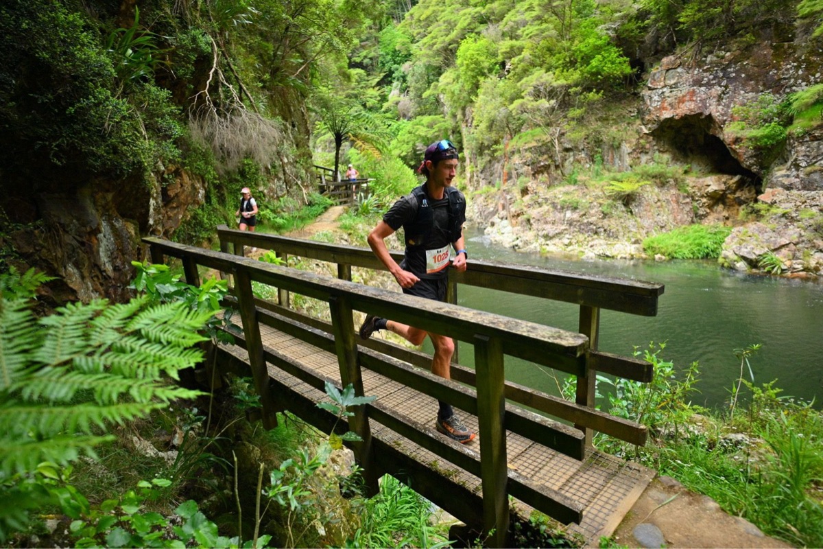 Pete crossing a footbridge during a trail ultramarathon in a New Zealand gorge